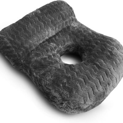 Grey plush ear-hole pillow with a round centre opening for side sleepers, shown on a white background.